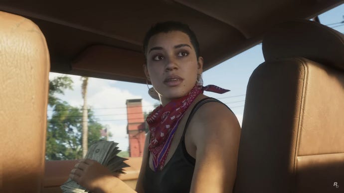 One of the protagonists of GTA 6 looks behind her seat in a car wearing a red bandana and holding a wad of cash.