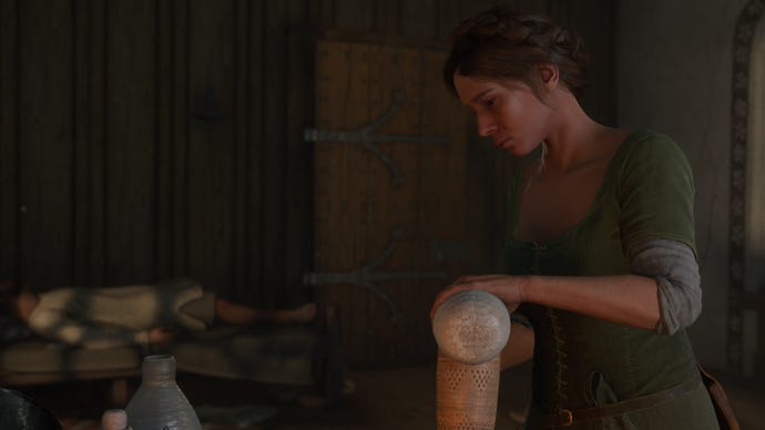 Adela, a character in Kingdom Come: Deliverance 2, pours a Fever Tonicum potion into a receptacle while her brother Sir Thomas lies in bed in the background.