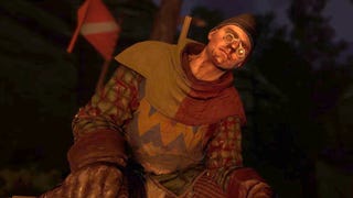 A very drunk Henry, wearing a funny hat and spectacles, engages in conversation during a nighttime cutscene in Kingdom Come: Deliverance 2.