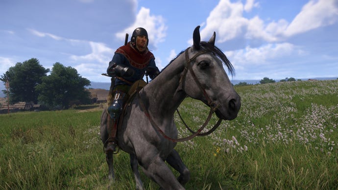 Henry rides his horse, Pebbles, through a field in Kingdom Come: Deliverance 2.