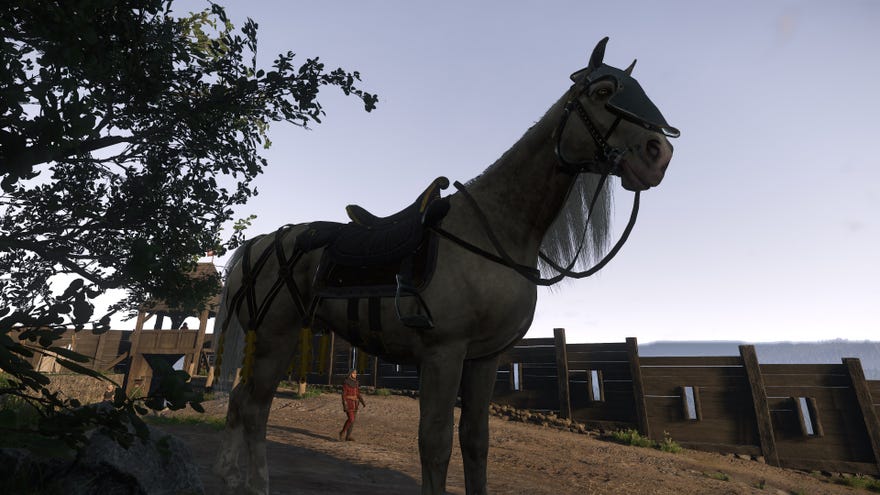 A fancy white horse, clad in saddle and armour, stands in Trosky Castle in Kingdom Come: Deliverance 2.