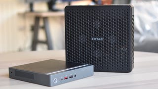 Two mini PCs, the Acer Revo Box and the Zotac ZBOX Magnus EN374070C, on a table.