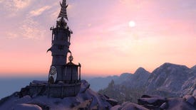 A tower sits atop a mountain, the sun sets in the distance.