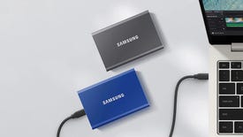 Blue and grey Samsung T7 SSDs next to a laptop.